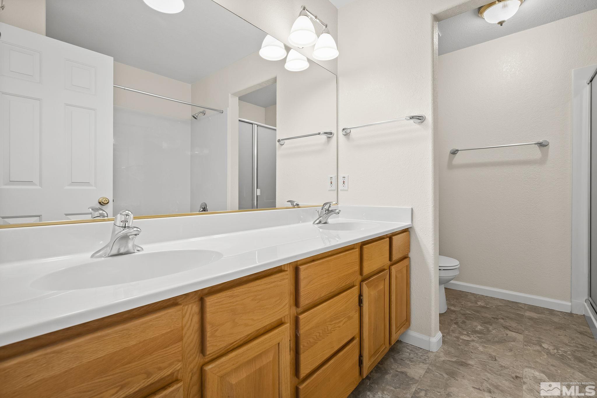 1352 Antelope Valley Road Reno, NV 89506 - Photo 18 of 36 a bathroom with a double vanity sink and a toilet