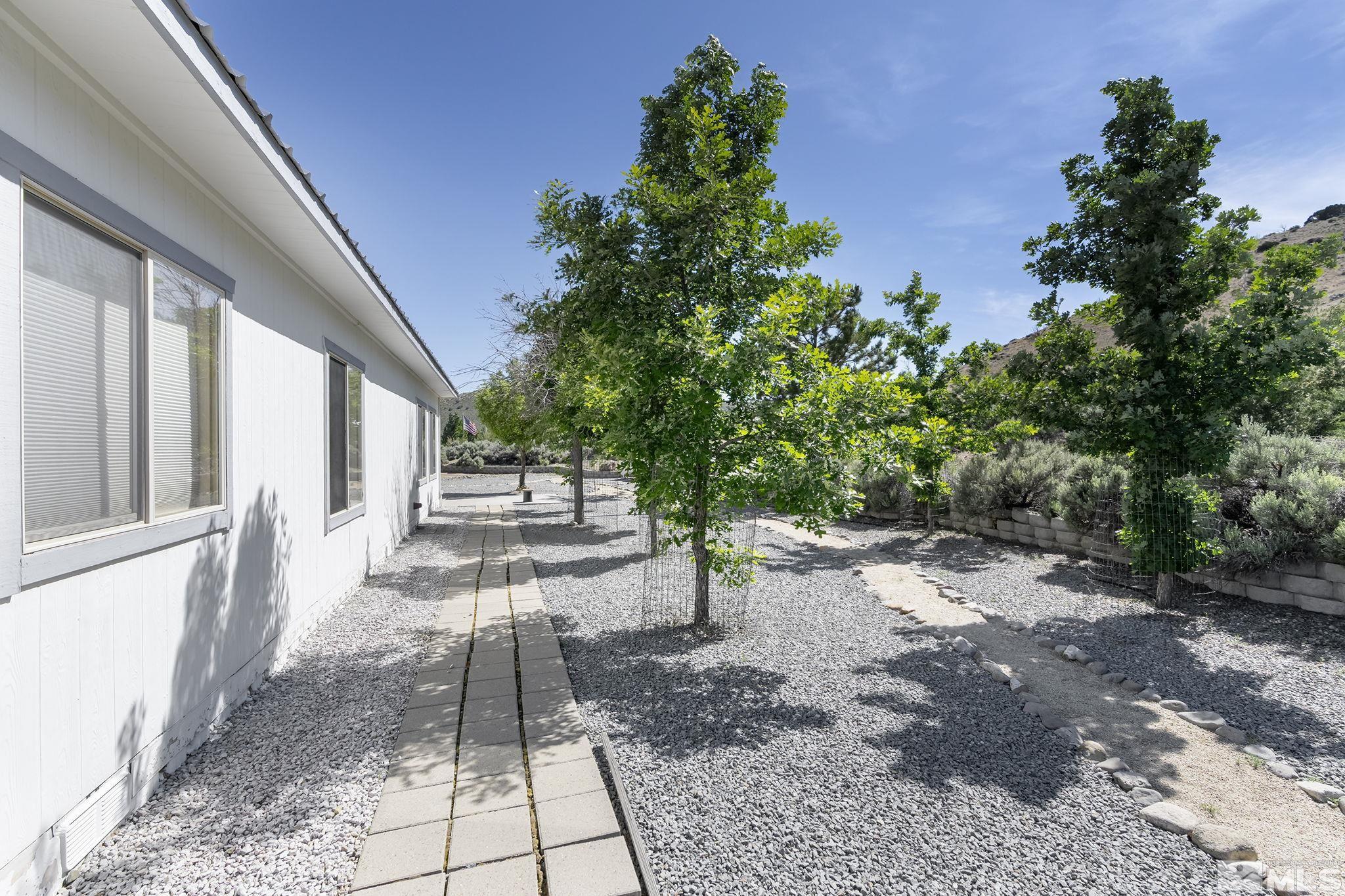 1352 Antelope Valley Road Reno, NV 89506 - Photo 20 of 36 a view of a patio with table and chairs and potted plants with wooden fence