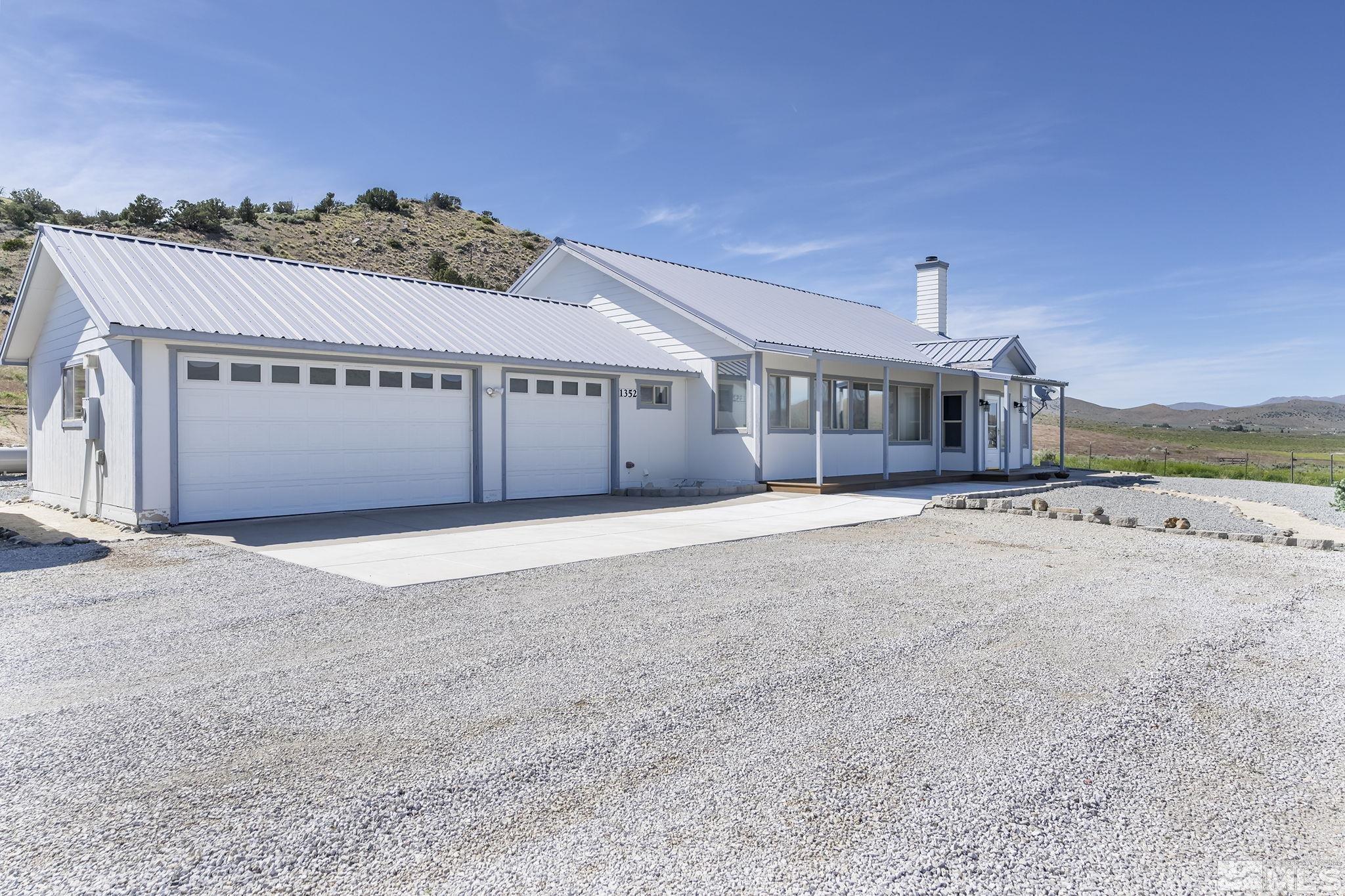 1352 Antelope Valley Road Reno, NV 89506 - Photo 2 of 36 a front view of a house with a yard and garage
