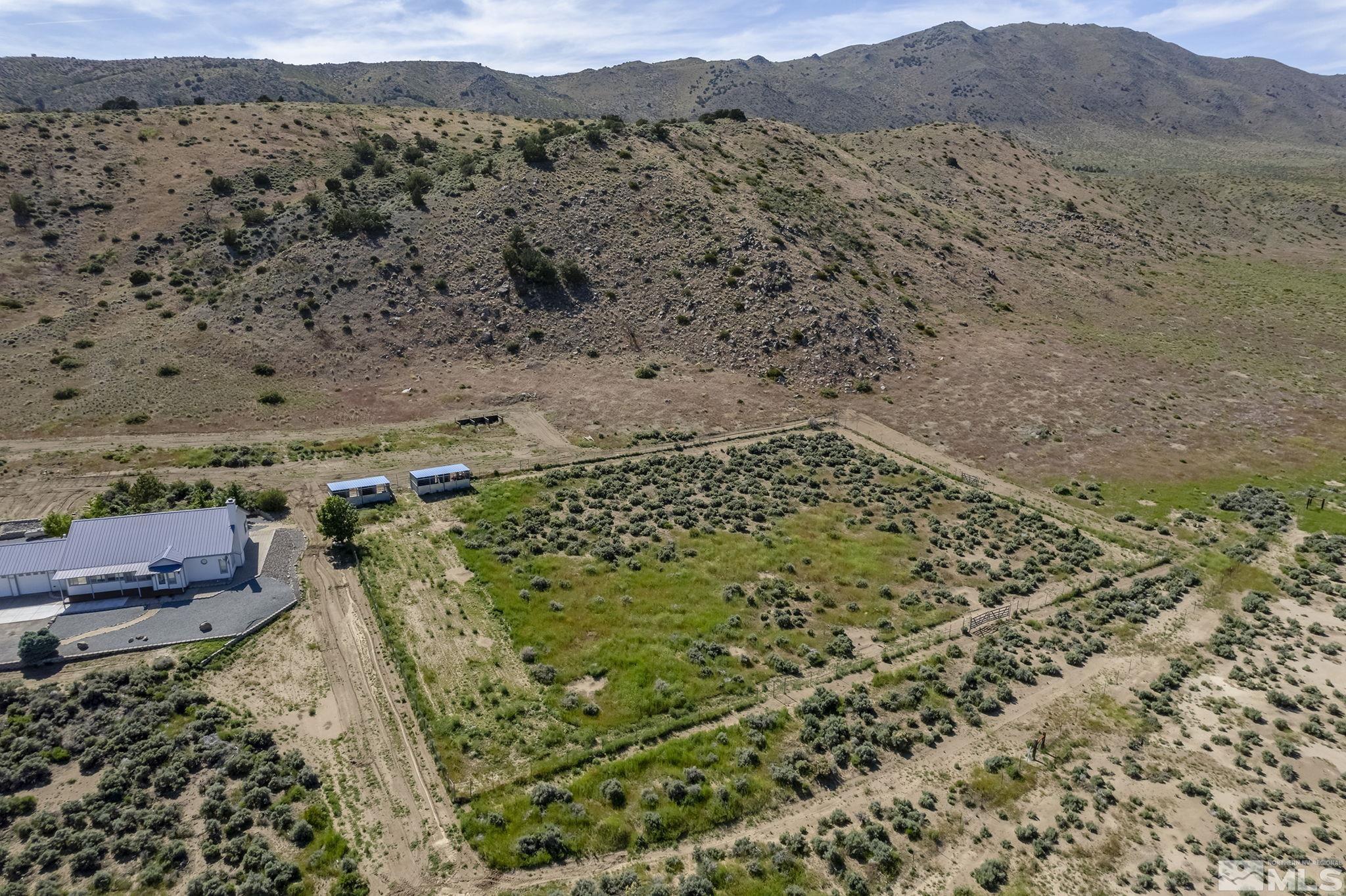 1352 Antelope Valley Road Reno, NV 89506 - Photo 32 of 36 a view of a dry yard with mountains in the background