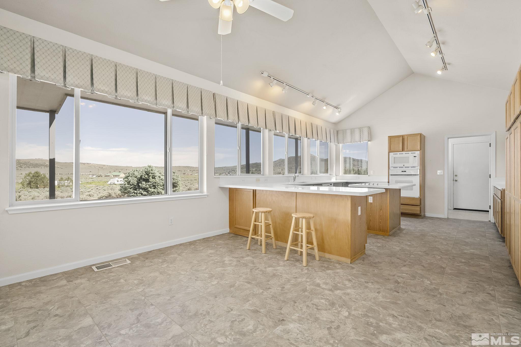 1352 Antelope Valley Road Reno, NV 89506 - Photo 7 of 36 a living room with kitchen island granite countertop furniture and a large window