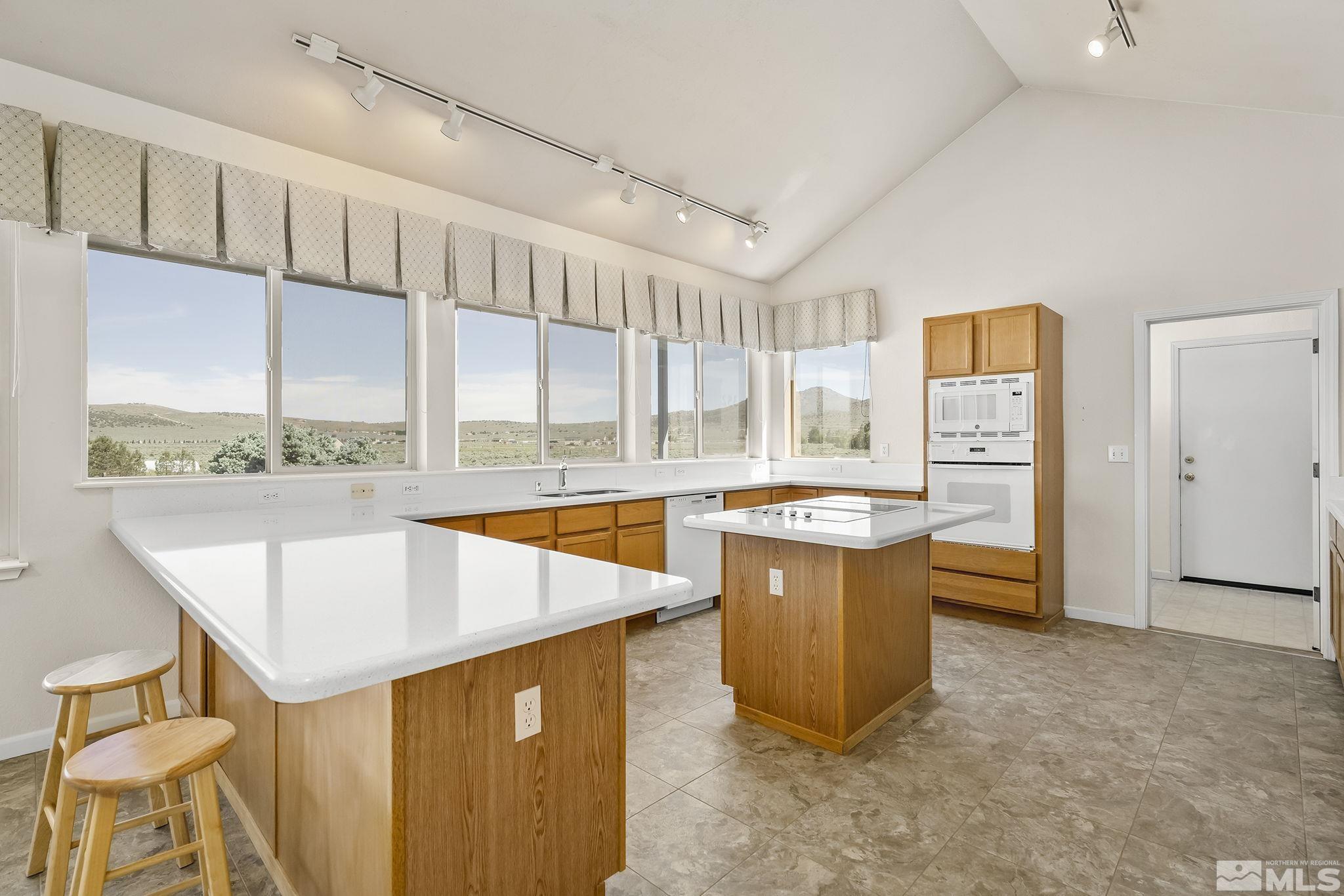 1352 Antelope Valley Road Reno, NV 89506 - Photo 8 of 36 a large kitchen with stainless steel appliances wooden floor and a large window