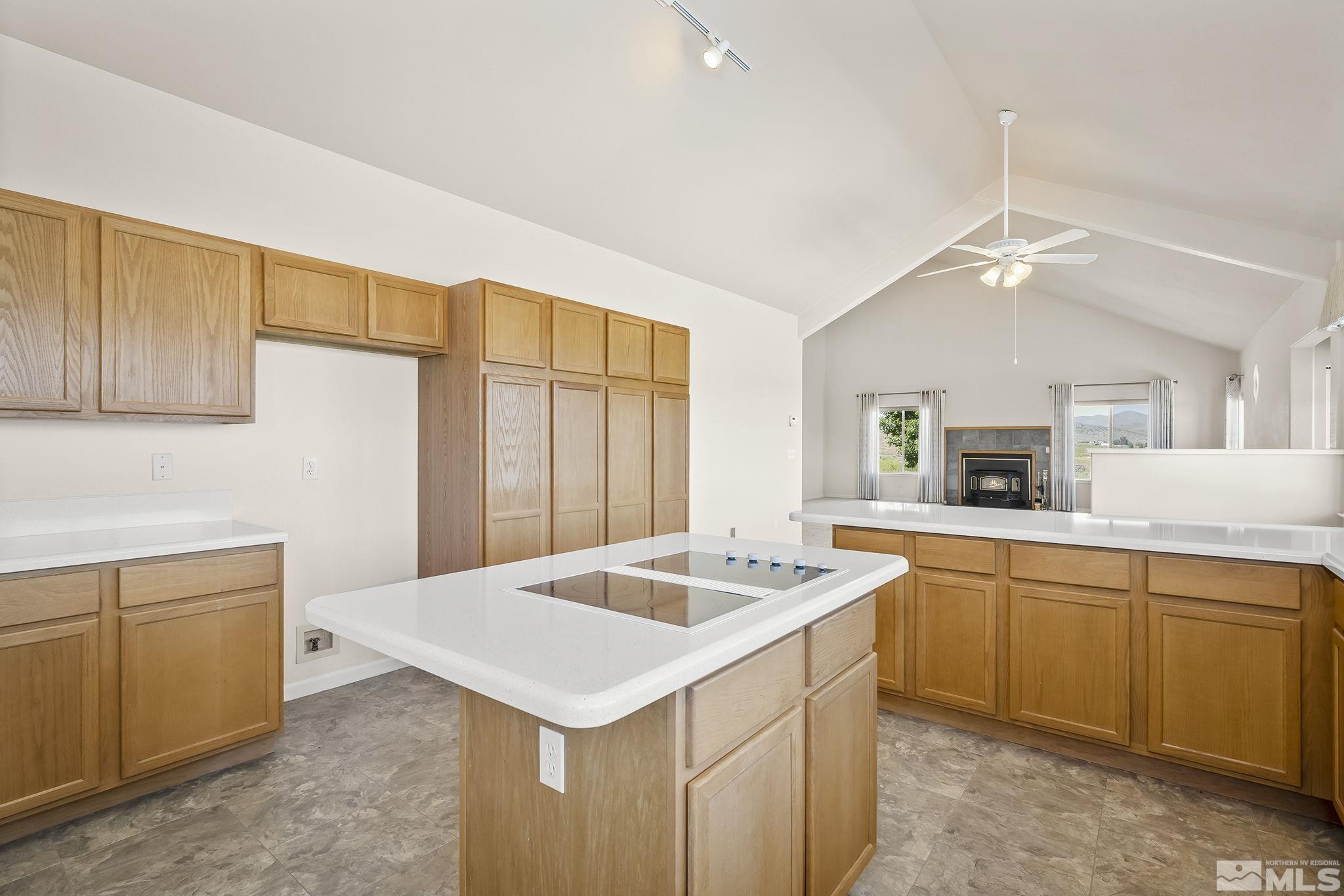 1352 Antelope Valley Road Reno, NV 89506 - Photo 10 of 36 a kitchen that has a sink a microwave oven a stove and white countertops with cabinets