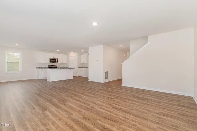 a view of kitchen with granite countertop cabinets and wooden floor