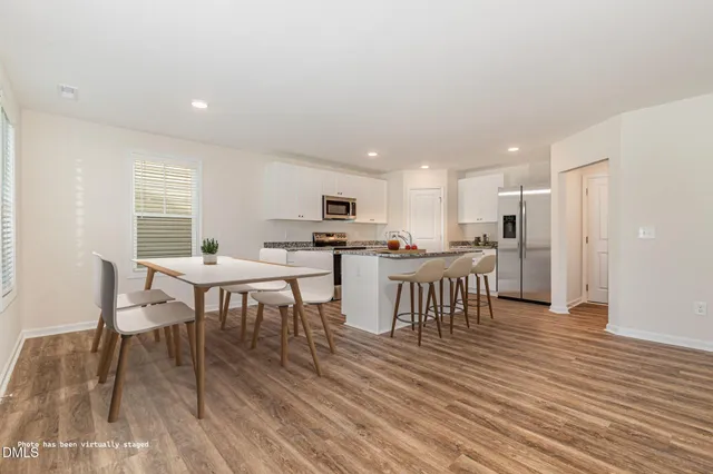 a view of a dining room with furniture and wooden floor
