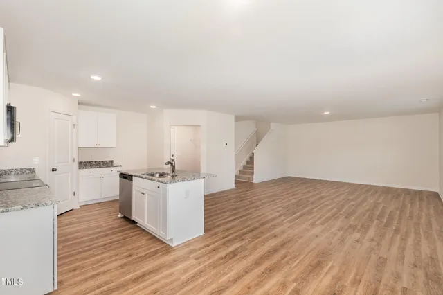 a view of kitchen with wooden floor and electronic appliances