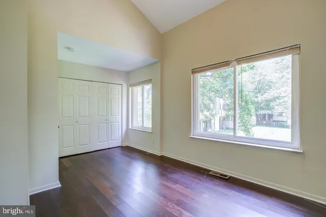 a view of front door with wooden floor and stairs