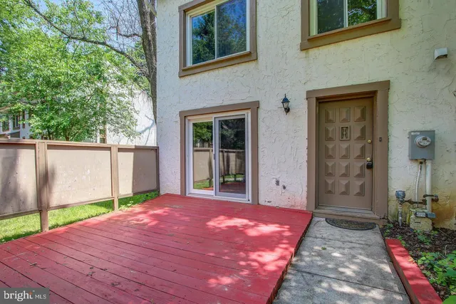 a view of a backyard with table and chairs and wooden fence