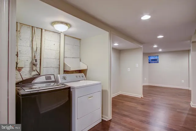 an empty room with wooden floor and entrance