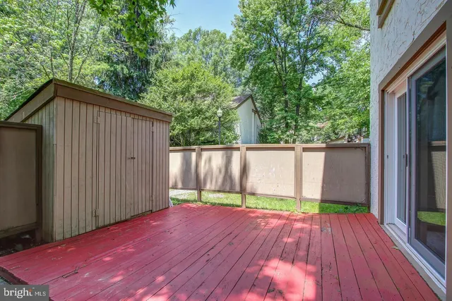 a view of backyard with a deck and wooden floor