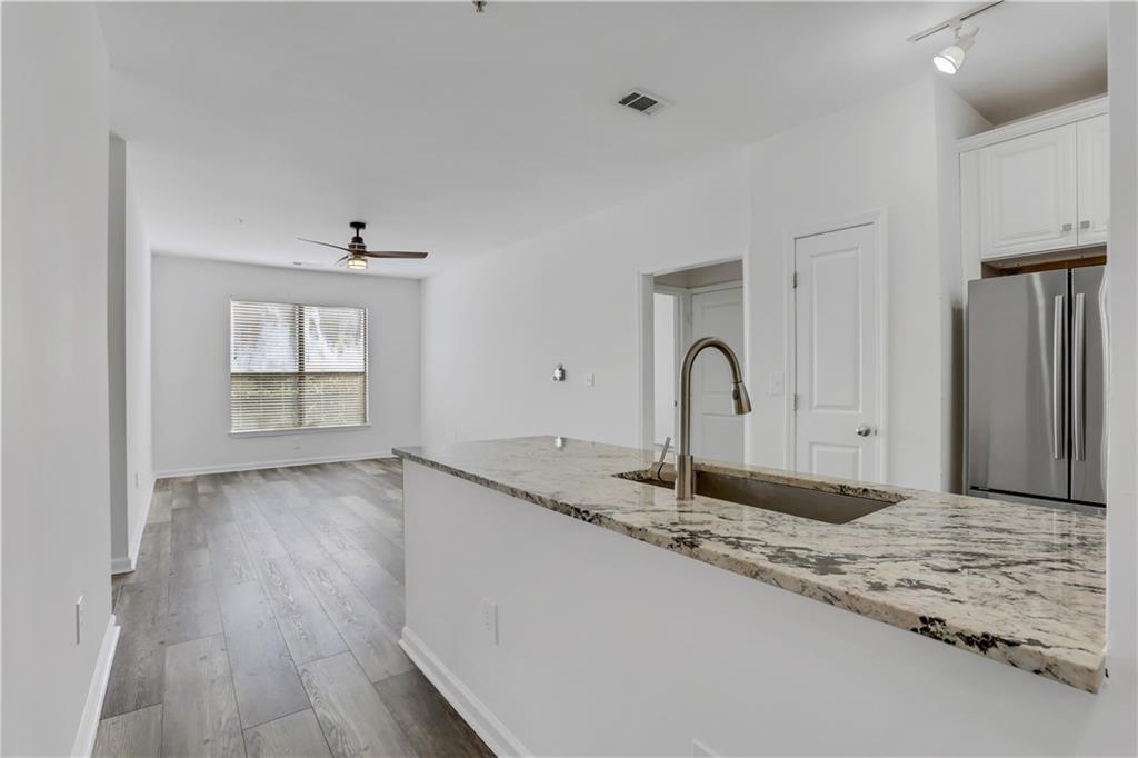 821 Ralph McGill Boulevard Northeast, Unit 3223 Atlanta, GA 30306 - Photo 1 of 1 a bathroom with a granite countertop sink and a window