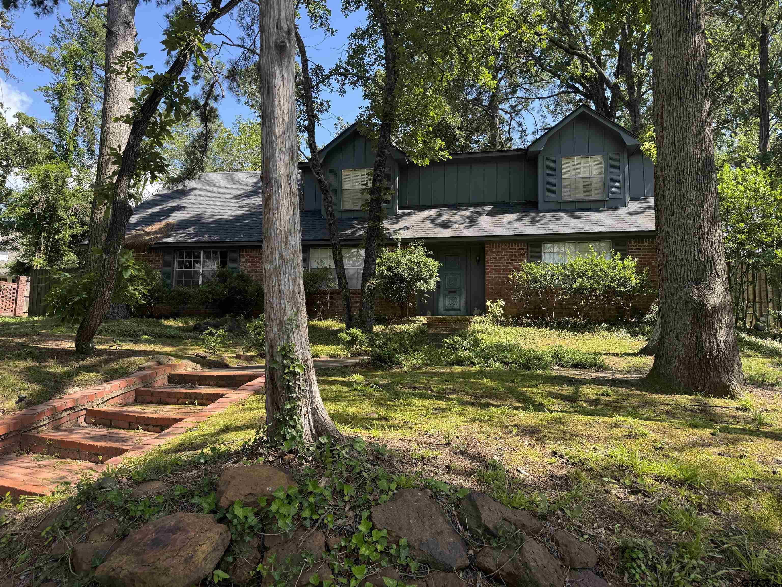 1113 East Amherst Drive Tyler, TX 75701 - Photo 1 of 7 a view of a house with a yard garage and large tree