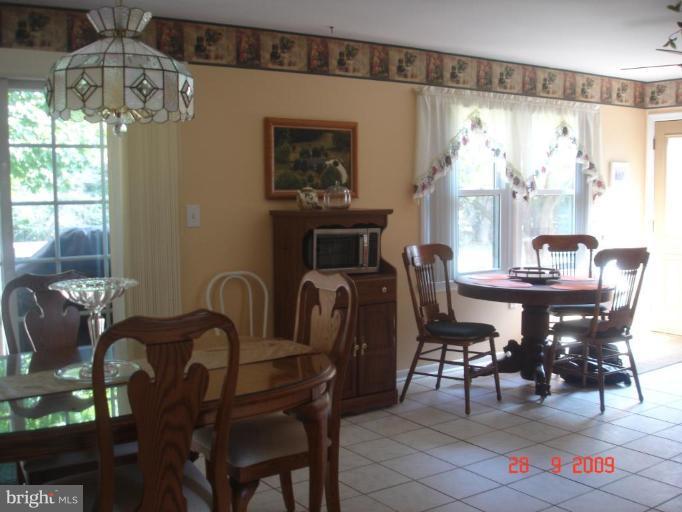 3805 Houcks Road Monkton, MD 21111 - Photo 25 of 29 a dining room with furniture a chandelier and window