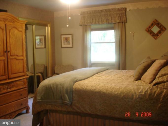 3805 Houcks Road Monkton, MD 21111 - Photo 10 of 29 a bedroom with a bed and a window