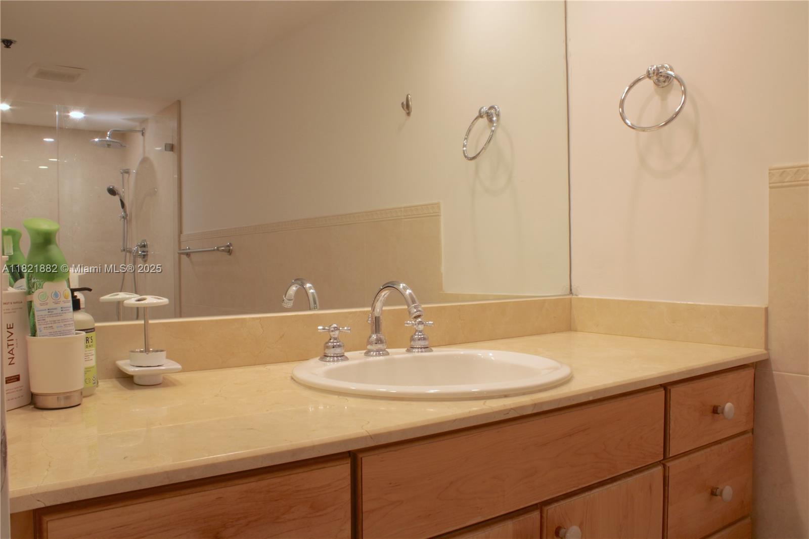 201 Crandon Boulevard, Unit 439 Key Biscayne, FL 33149 - Photo 11 of 24 a bathroom with a sink and a mirror