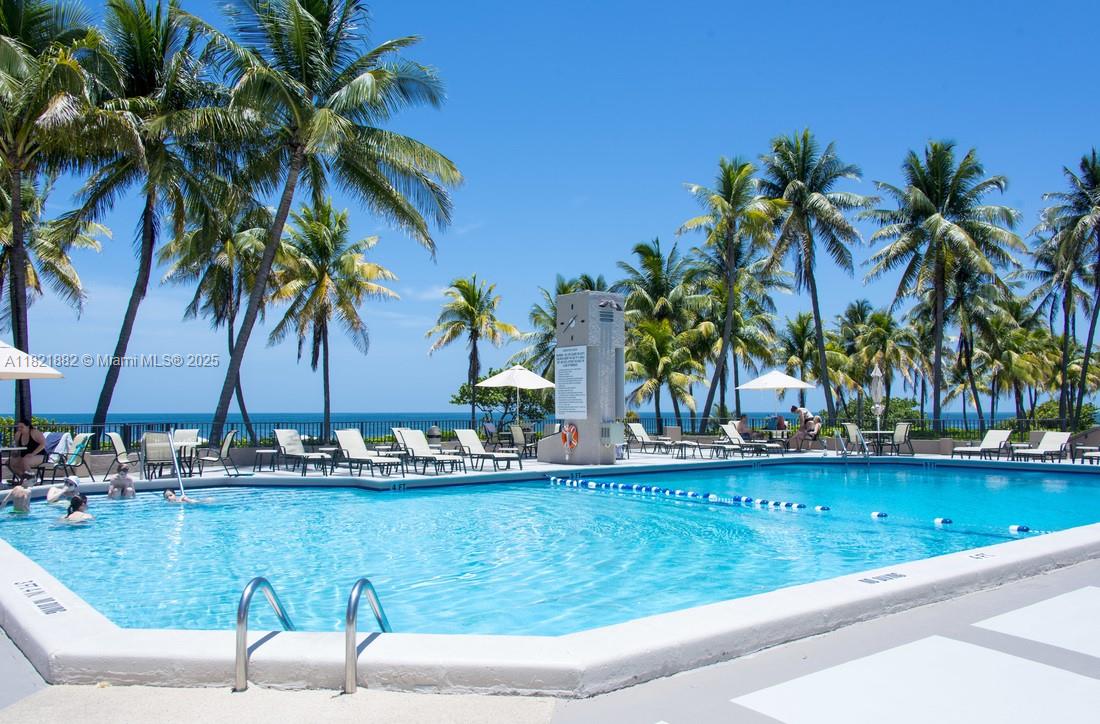 201 Crandon Boulevard, Unit 439 Key Biscayne, FL 33149 - Photo 20 of 24 a view of swimming pool with a table and chairs