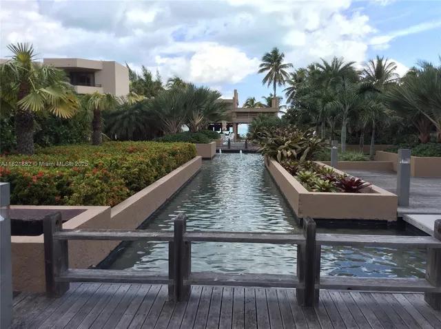 a view of a swimming pool with a garden and plants