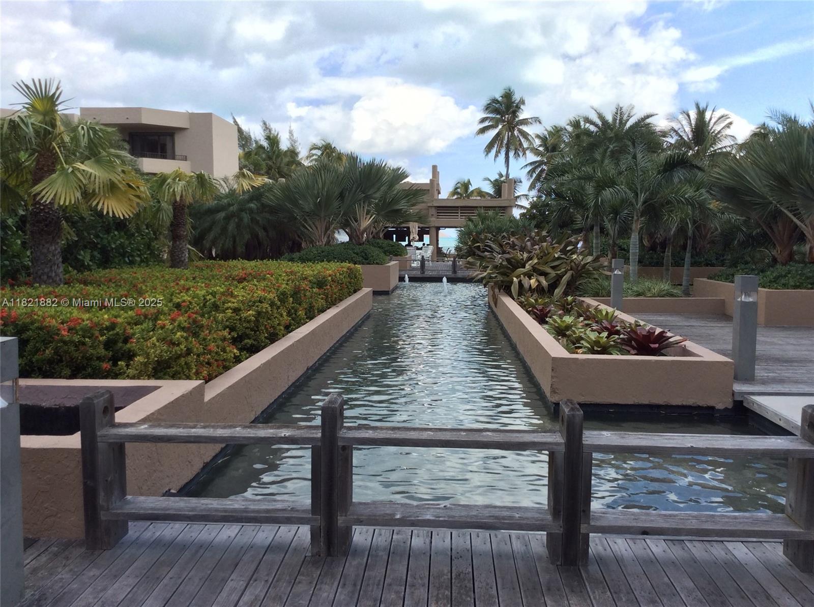 201 Crandon Boulevard, Unit 439 Key Biscayne, FL 33149 - Photo 21 of 24 a view of a swimming pool with a patio and a yard