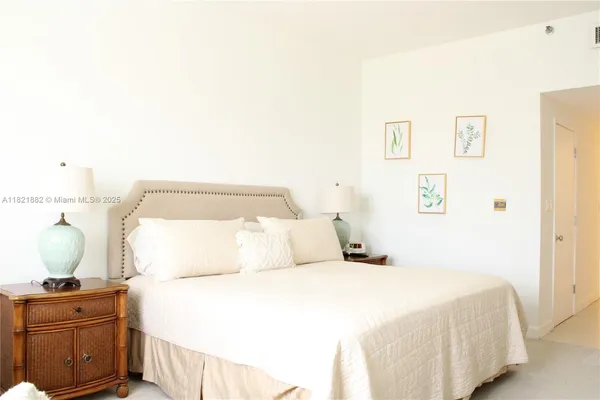 a bedroom with a bed and cabinet