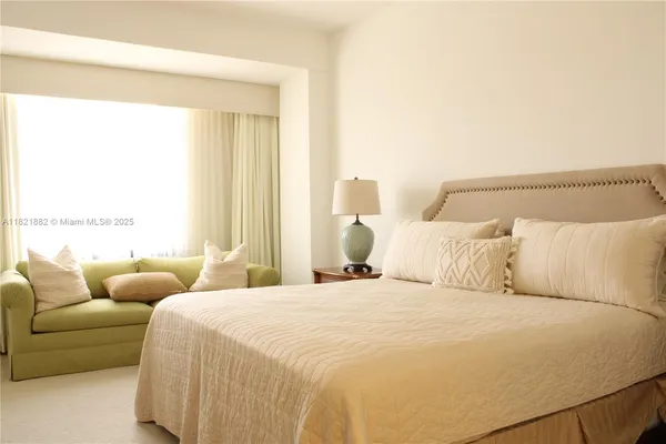 a bedroom with bed and a couch