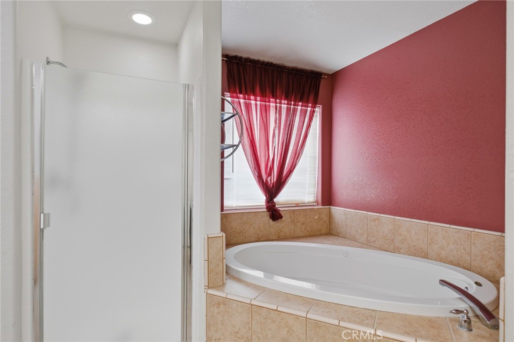 11025 El Esteban Road Phelan, CA 92371 - Photo 35 of 54 a bathroom with a bathtub and a shower