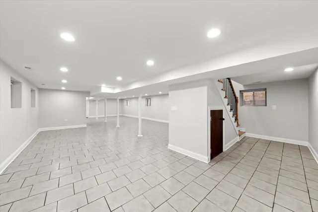 an empty room with white walls and tiles