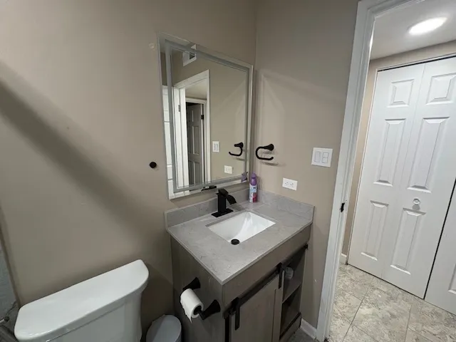 a bathroom with a sink toilet and mirror