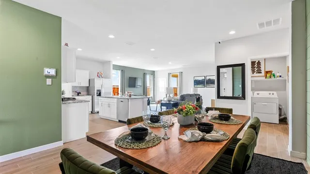 a kitchen with stainless steel appliances granite countertop a sink stove and cabinets
