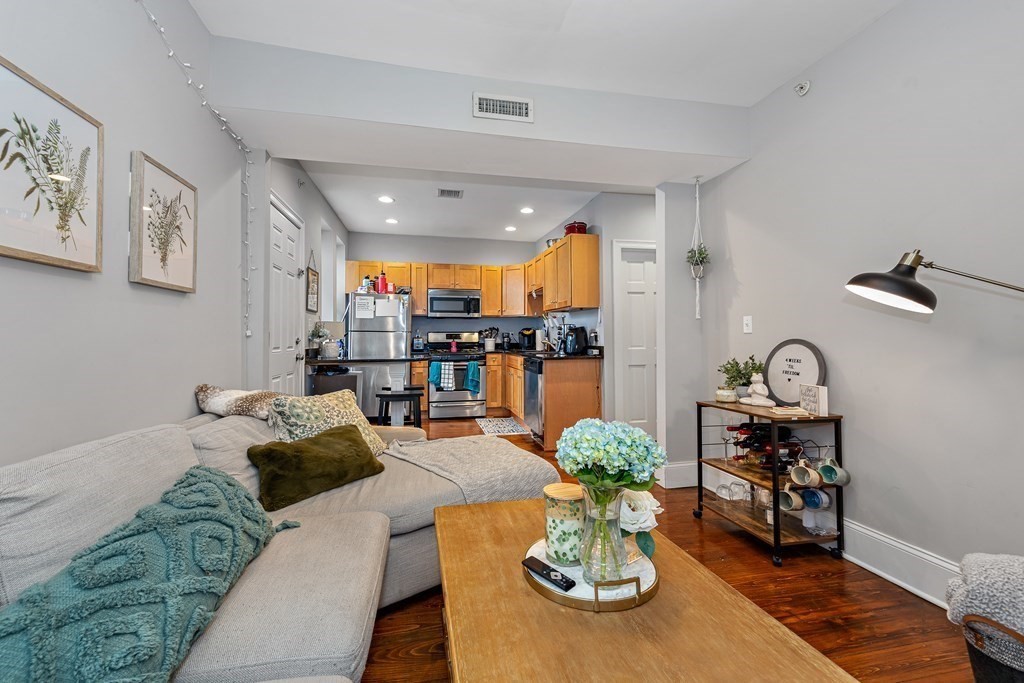 a living room with furniture and wooden floor