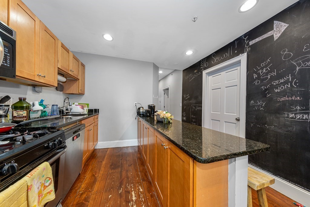 16 Sewall Street Boston, MA 02120 - Photo 21 of 42 a kitchen with granite countertop sink stainless steel appliances and cabinets