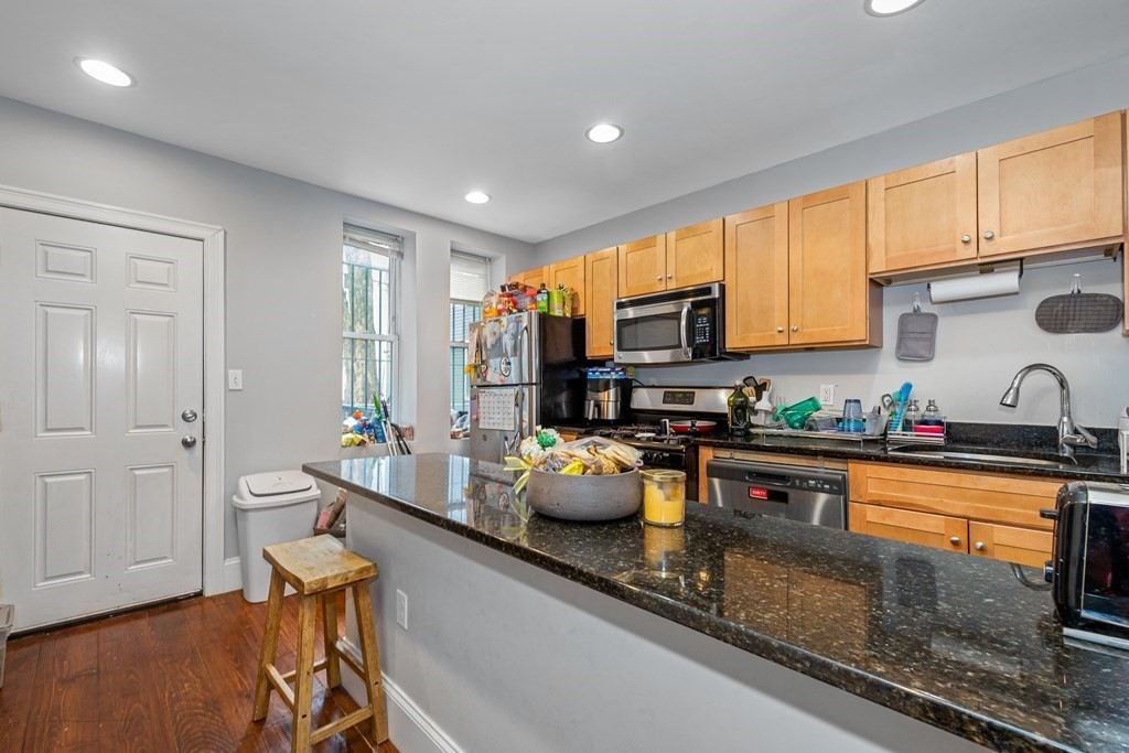 16 Sewall Street Boston, MA 02120 - Photo 23 of 42 a kitchen with stainless steel appliances granite countertop a sink refrigerator and microwave
