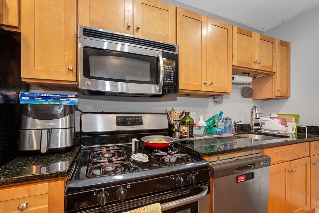 16 Sewall Street Boston, MA 02120 - Photo 24 of 42 a kitchen with stainless steel appliances granite countertop a stove and a microwave