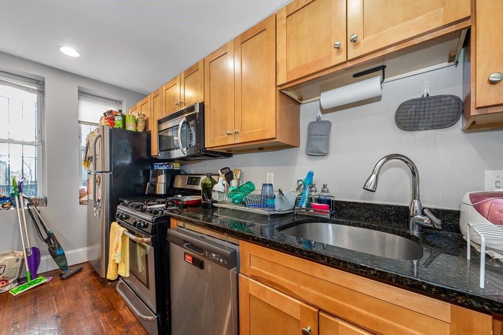 16 Sewall Street Boston, MA 02120 - Photo 25 of 42 a kitchen with stainless steel appliances granite countertop a sink a stove and cabinets