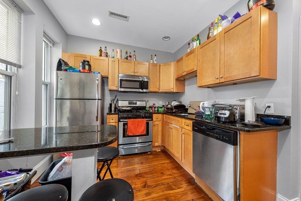 16 Sewall Street Boston, MA 02120 - Photo 27 of 42 a kitchen with stainless steel appliances granite countertop a refrigerator and a stove top oven