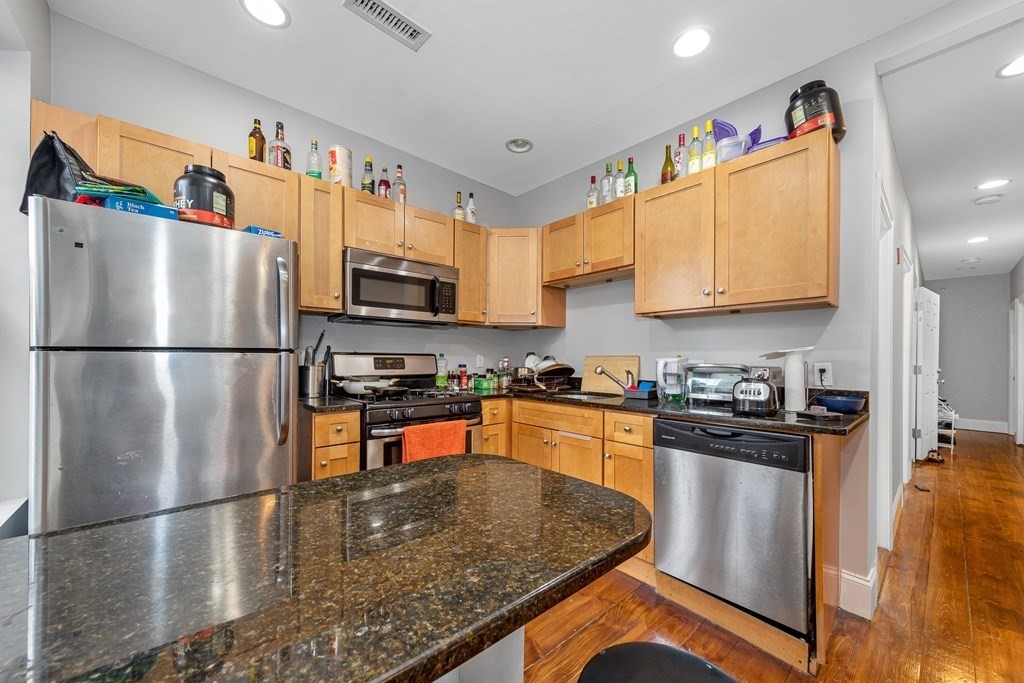 16 Sewall Street Boston, MA 02120 - Photo 28 of 42 a kitchen with stainless steel appliances granite countertop a refrigerator a stove a sink and a microwave