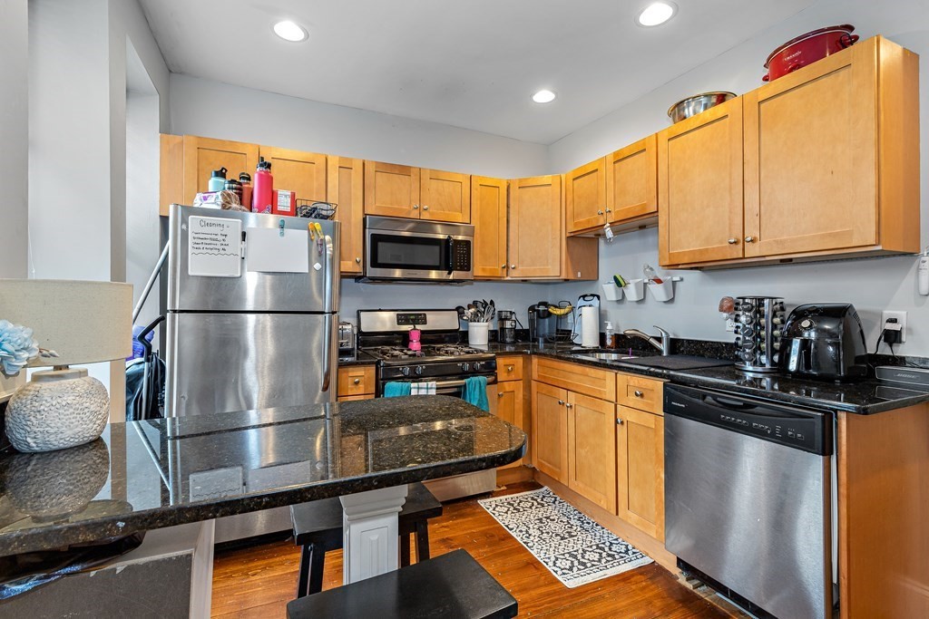 16 Sewall Street Boston, MA 02120 - Photo 8 of 42 a kitchen with stainless steel appliances granite countertop a refrigerator stove top oven and sink