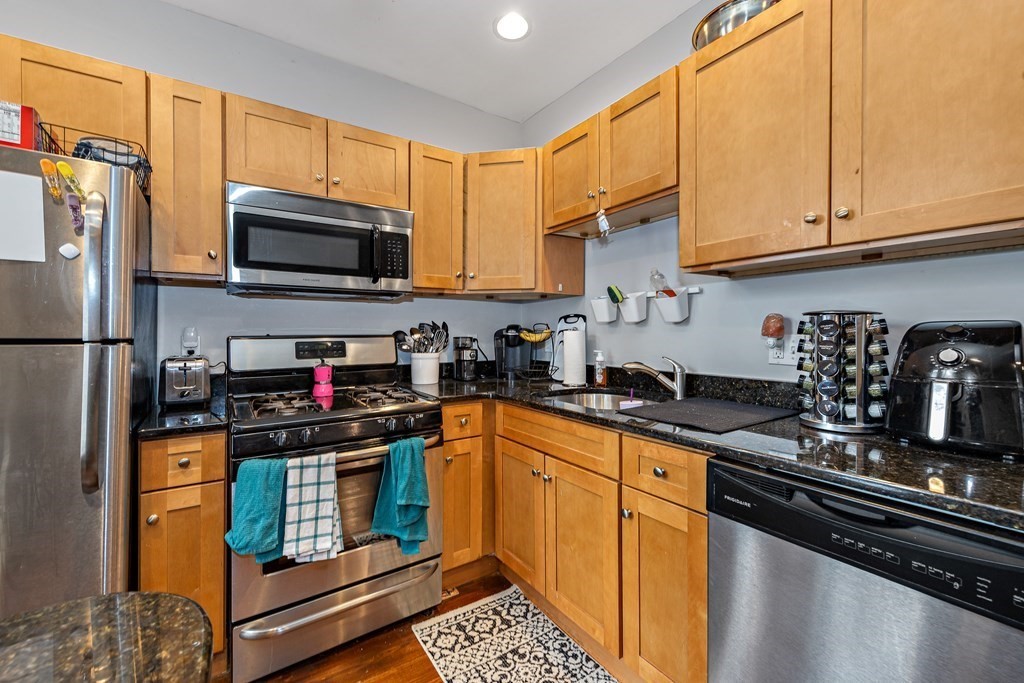 16 Sewall Street Boston, MA 02120 - Photo 9 of 42 a kitchen with stainless steel appliances granite countertop a refrigerator stove top oven and sink