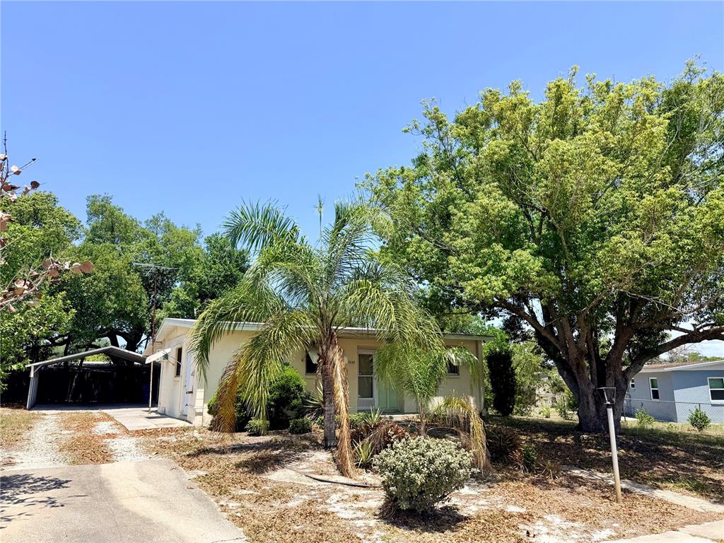 7055 Merrick Lane Spring Hill, FL 34606 - Photo 2 of 17 a front view of a house with a yard