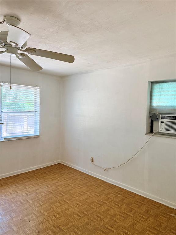 7055 Merrick Lane Spring Hill, FL 34606 - Photo 5 of 17 a view of a room with window and a ceiling fan