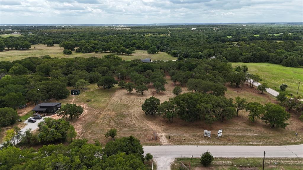 1895 Sunflower Road, Unit LOT 2 Paradise, TX 76073 - Photo 13 of 25 an aerial view of residential houses with outdoor space and trees