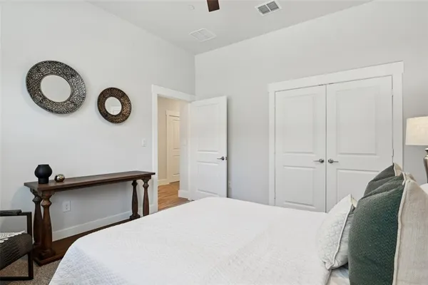 a bedroom with a bed and a window