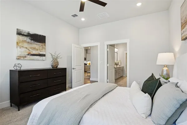 a bedroom with a bed and a painting on the wall