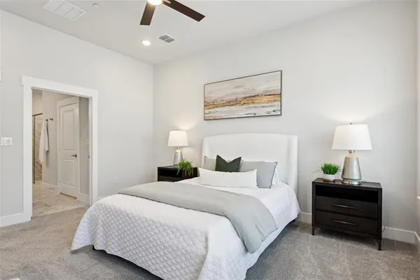 a bedroom with bed and a chandelier