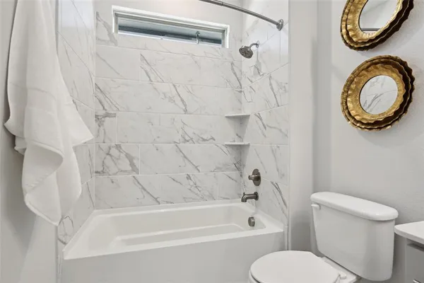 a bathroom with a toilet and a bathtub