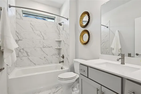 a bathroom with a sink a toilet and a bathtub