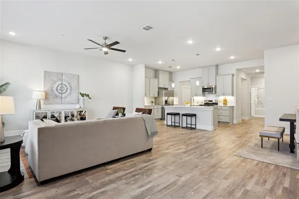 a living room with furniture and kitchen view