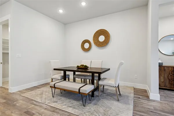 a view of a room with a table and chairs