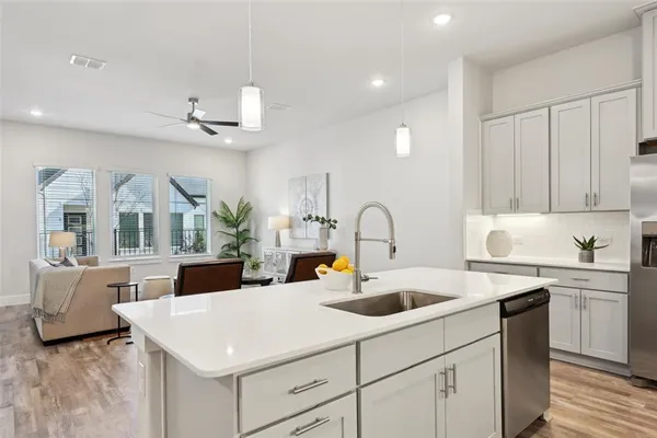 a kitchen with a white cabinets and chandelier