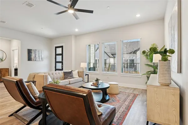 a living room with furniture a window and a chandelier