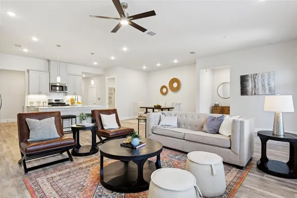 a living room with furniture and kitchen view